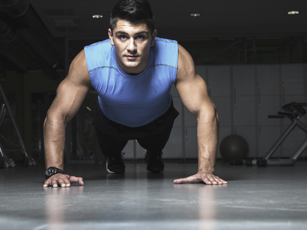 Healthy young guy doing push up exercise Hottest Fitness Trends for 2015