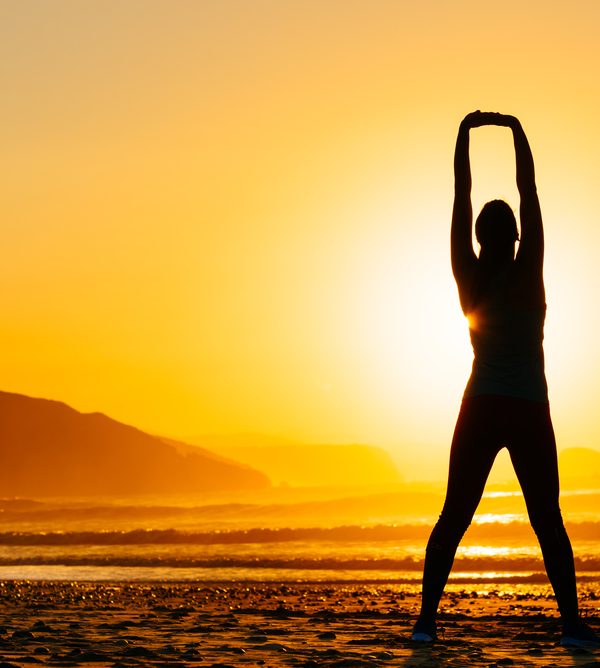 Fitness,Woman,Exercising,And,Stretching,Arms,On,Beautiful,Summer,Sunset